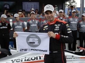 Will Power poses after qualifying on the pole for Sunday's IndyCar series auto race, Saturday, Aug. 18, 2018, in Long Pond, Pa.