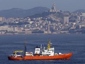 FILE - In this Aug.1, 2018 file photo, the French NGO "SOS Mediterranee" Aquarius ship leaves the Marseille harbor, southern France. he European Commission said Monday Aug.13, 2018 that it is in contact with a number of member states to identify a country willing to take 141 migrants picked up by a rescue ship, after the French aid groups operating the ship appealed for a safe port and Italy said Britain should take responsibility.