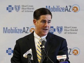 FILE--In this Aug. 14, 2018, file photo, Republican Arizona Gov. Doug Ducey speaks at a news conference in Phoenix. Ducey and a Democratic Hispanic education professor appeared likely to win their parties' respective nods in the primary election for Arizona's top office. Both Ducey and Democratic front runner David Garcia earlier announced suspension of campaign gatherings later in the week when events are planned to honor Sen. John McCain, who died Saturday from brain cancer,