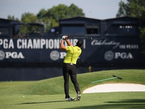 Rickie Fowler, wearing a yellow shirt to honour Jarrod Lyle, plays a shot at the PGA Championship on Aug. 9.