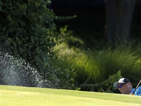 Stewart Cink hits out of a bunker on the 17th hole during the third round of the PGA Championship golf tournament at Bellerive Country Club, Saturday, Aug. 11, 2018, in St. Louis.