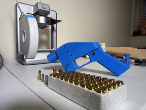 A Liberator pistol appears next to the 3D printer on which its components were made in Hanover, Md., in a photo taken in July 2013.