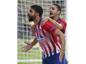 Atletico's Diego Costa, left, celebrates with teammate Atletico's Koke, right, after scoring his sides first goal during the UEFA Super Cup final soccer match between Real Madrid and Atletico Madrid at the Lillekula Stadium in Tallinn, Estonia, Wednesday, Aug. 15, 2018.