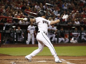 Arizona Diamondbacks' David Peralta watches the flight of his two-run home run against the Los Angeles Angels during the first inning of a baseball game Tuesday, Aug. 21, 2018, in Phoenix.
