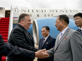 In this July 6, 2018, file photo, U.S. Secretary of State Mike Pompeo, second from left, is greeted by North Korean Director of the United Front Department Kim Yong Chol, center, and North Korean Foreign Minister Ri Yong Ho, second from right, as he arrives at Sunan International Airport in Pyongyang, North Korea. Media controlled by the Pyongyang regime has been careful not to criticize Trump directly since his June 12 meeting with North Korean leader Kim Jong Un, reserving its occasional ire for Pompeo and other members of the administration.