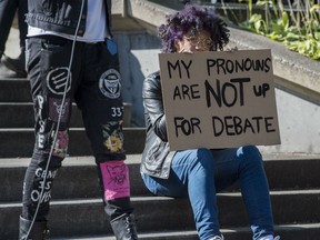 Quinn Valkyrie holds a sign in protest of anti political correctness professor Jordan Peterson, who has refused to refer to transgender people by their chosen pronouns, at University of Toronto in Toronto, Ontario, Wednesday October 5, 2016.