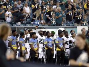 Philadelphia Eagles' Malcolm Jenkins, center left, raises his fist during the national anthem before the team's preseason NFL football game against the Pittsburgh Steelers, Thursday, Aug. 9, 2018, in Philadelphia.