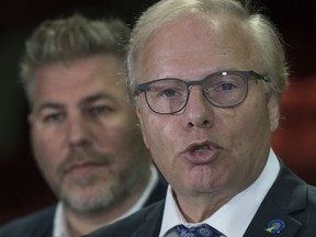 arti Quebecois Leader Jean-Francois Lisee, right, speaks at a news conference Tuesday, August 28, 2018, in Quebec City. Matane candidate Pascal Berube looks on. Lisee has invited leaders of Quebec's other political parties to sign a common declaration to protect — "at all costs" — supply management and Quebec culture.