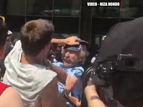 Video obtained by the Toronto Sun shows an attack on Sun photographer at a Saturday rally outside Toronto city hall.