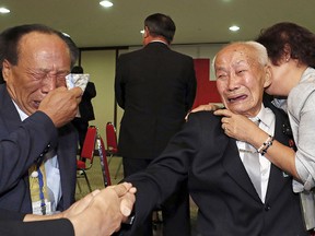 Eighty-eight-year-old North Korean Cho Deok Yong, right, weeps with his South Korean son, Cho Jeong-gi, 67, during a Separated Family Reunion Meeting in North Korea on Aug. 24, 2018.