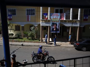 In this Aug. 18, 2018 photo, flags and a banner carrying the Spanish message: "Muriel Bowser, Welcome to Intipuca City, The Place To Be!" hangs in the central plaza after a recent visit by the Washington D.C. mayor in Intipuca, El Salvador. Some 5,000 of the town's 12,000 residents live in D.C., including the mayor's hairdresser.