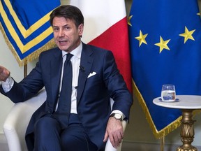 Italian Prime Minister Giuseppe Conte gestures as he talks during his press conference at Chigi Palace in Rome, Italy, Wednesday, Aug. 8, 2018. Italian Premier Giuseppe Conte said Wednesday his country is willing to consider "more rigorous accords" on Iran, adding that he recently asked U.S. President Donald Trump to share intelligence about Iran's alleged nuclear program that has triggered fresh U.S. sanctions.