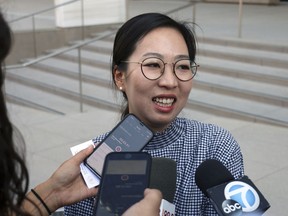 Yea Ji Sea, a former U.S. Army specialist who was born in South Korea, talks with reporters after a federal court hearing in Los Angeles Tuesday, Aug. 14, 2018. Sea filed a lawsuit in July, 2018, demanding a response to her citizenship application after the military moved to discharge her. She has since been discharged. U.S. District Judge Michael Fitzgerald says the government will have to rule on Sea's application by Sept. 5 or explain the delay to the court.
