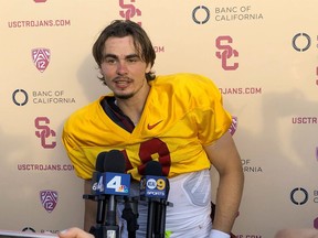 Southern California quarterback J.T. Daniels speaks to reporters following his first NCAA college football practice after winning the Trojans' starting job, Tuesday, Aug. 28, 2018, in Los Angeles. The 18-year-old Daniels will be the first true freshman to start at quarterback for USC's powerhouse program since 2009.