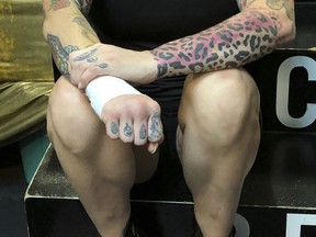 In this Thursday, Aug. 16, 2018 photo Bec Rawlings, of Australia, clenches her fist after getting her wrist taped in preparation for a bare-knuckle sparring session at City of Angels Boxing Club in Los Angeles. Rawlings is a longtime UFC fighter who will fight on the second sanctioned bare-knuckle boxing show in the U.S. in over a century on Saturday, Aug. 25, 2018, in Biloxi, Miss.