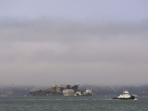 Hazy air surrounds Alcatraz Island in San Francisco Bay Wednesday, Aug. 8, 2018. The air quality has hit unhealthy levels in cities miles away as California's largest wildfire ever burns to the north.