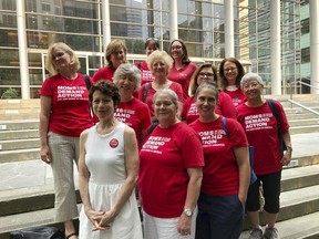 Members of the Washington Chapter of Moms Demand Action pose for a photo outside the federal courthouse in Seattle, Wash., Tuesday, Aug. 21, 2018, after attending a hearing to support the issuance of an injunction to block the online release of plans for printing 3D guns. A federal judge hearing arguments over whether the Trump administration should be allowed to maintain a settlement with a company that wants to post online plans for printing 3D guns said Tuesday that the issue should be decided by the president or Congress.