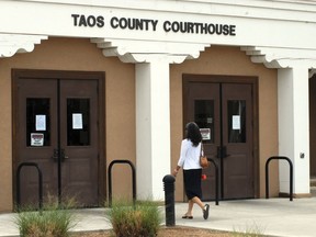 The Taos County Courthouse, where three people accused of child abuse at a desert compound are awaiting release, is shown Wednesday, Aug. 15, 2018, in Taos, N.M. Security was boosted at the judiciary complex amid threats against the state judge who cleared the way for the defendants to leave jail.