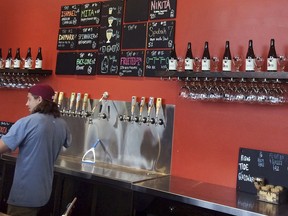 In this July 30, 2018 photo, Josh Maner slings draft beers at Rising Tide in Portland, Maine. Rising Tide is one of several breweries in the Portland area that offer tours.