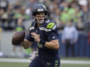 Seattle Seahawks quarterback Austin Davis looks to pass against the Oakland Raiders during the first half of an NFL football preseason game, Thursday, Aug. 30, 2018, in Seattle.