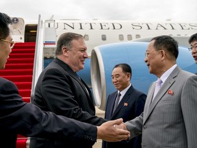 FILE - In this July 6, 2018, file photo, U.S. Secretary of State Mike Pompeo, second from left, is greeted by North Korean Director of the United Front Department Kim Yong Chol, center, and North Korean Foreign Minister Ri Yong Ho, second from right, as he arrives at Sunan International Airport in Pyongyang, North Korea. South Korea on Saturday, Aug. 25, 2018, called the U.S. decision to call off a trip to North Korea by Pompeo "unfortunate" and said continued diplomacy would be most crucial in resolving the nuclear standoff with the North.