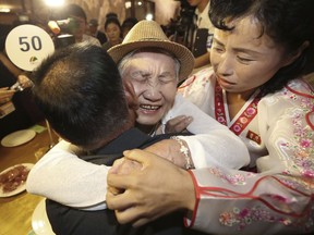 South Korean Lee Keum-seom, 92, center, hugs her North Korean son Ri Sang Chol, 71, left, with Kim Ok Hui, daughter-in-law of Ri Sang Chol during the Separated Family Reunion Meeting at the Diamond Mountain resort in North Korea, Monday, Aug. 20, 2018. Dozens of elderly South Koreans crossed the heavily fortified border into North Korea on Monday for heart-wrenching meetings with relatives most haven't seen since they were separated by the turmoil of the Korean War.