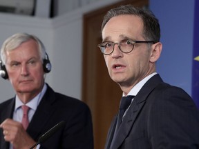 German Foreign Minister Heiko Maas, right, and the European Union chief Brexit negotiator Michel Barnier, left, address the media during a joint press conference as part of a meeting at the Foreign Ministry in Berlin, Germany, Wednesday, Aug. 29, 2018.