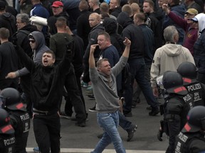 Men shout during a far-right protest in Chemnitz, Germany, Monday, Aug. 27, 2018 after a man has died and two others were injured in an altercation between several people of "various nationalities" in the eastern German city of Chemnitz on Sunday.