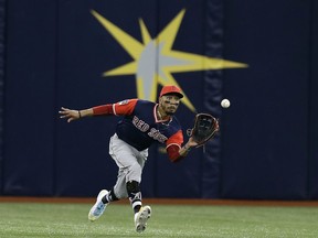 Boston Red Sox center fielder Mookie Betts makes a running catch on a fly-out by Tampa Bay Rays' Ji-Man Choi during the first inning of a baseball game Saturday, Aug. 25, 2018, in St. Petersburg, Fla.