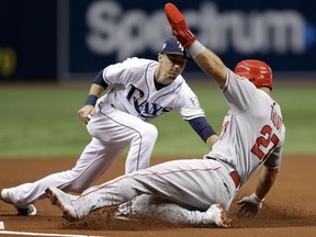 Los Angeles Angels' Mike Trout (27) gets tagged out by Tampa Bay Rays third baseman Matt Duffy while trying to steal third base during the first inning of a baseball game Wednesday, Aug. 1, 2018, in St. Petersburg, Fla.