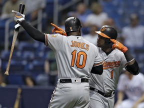 Baltimore Orioles' Tim Beckham (1) celebrates with on-deck batter Adam Jones (10) after Beckham hit a home run off Tampa Bay Rays pitcher Ryne Stanek during the first inning of a baseball game Wednesday, Aug. 8, 2018, in St. Petersburg, Fla.