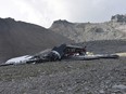 The photo provided by Police Graubuenden shows the wreckage of the old-time Ju-52 that went down went down Saturday on the Piz Segnas mountain above the Swiss Alpine resort of Flims.