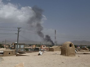 Smoke rising into the air after Taliban militants launched an attack on the Afghan provincial capital of Ghazni on August 10, 2018. - US forces launched airstrikes on August 10 to counter a major Taliban assault on an Afghan provincial capital, where terrified residents cowered in their homes amid explosions and gunfire as security forces fought to beat the insurgents back.