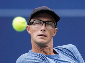 Peter Polansky returns a shot to Novak Djokovic at the Rogers Cup in Toronto on Aug. 8.