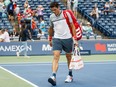Milos Raonic of Canada leaves the court after being beaten by Frances Tiafoe of the United States during second round of the Rogers Cup men's tennis tournament in Toronto on Wednesday night.