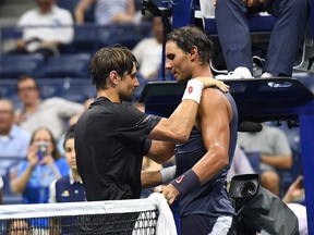David Ferrer (left) greets Rafael Nadal at the net after their first-round match at the U.S. Open on Aug. 27.