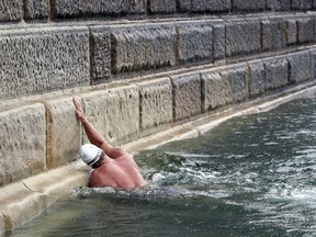 Lewis Pugh touches Dover harbour wall to complete his "Long Swim" from Land's End to Dover, England, Wednesday Aug. 29, 2018. The Channel Swimming Association says endurance athlete Lewis Pugh completed on Wednesday his 330-mile (530-kilometer) swim along the length of the English Channel from Land's End to Dover _ the first swimmer to do so.