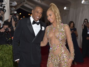 FILE- In this May 4, 2015, file photo, Jay Z, left, and Beyonce arrive at The Metropolitan Museum of Art's Costume Institute benefit gala celebrating "China: Through the Looking Glass" in New York. After bad weather forced concertgoers at the MetLife Stadium inside for close to an hour Thursday night, Aug. 2, 2018, Beyonce and Jay-Z hit the stage at 11:08 p.m. and played into Friday morning, wrapping the energetic show at 1:29 a.m.