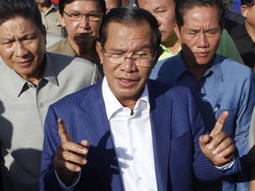 FILE - In this Aug. 1, 2018, file photo, Cambodian Prime Minister Hun Sen gestures while speaking in Phnom Penh, Cambodia. Cambodian Prime Minister Hun Sen, at the polling place near his home on the day of the general election on July 29, 2018. The official results, being announced province-by-province and party-by-party Wednesday, Aug. 15, 2018, were certain to confirm a landslide victory by Hun Sen's Cambodian People's Party, but critics called the election unfair because the only credible opposition force, the Cambodia National Rescue Party, could not contest the polls because it was dissolved by court order last year.