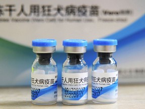 FILE - In this July 24, 2018, file photo, bottles of rabies vaccines made by Liaoning Chengda are seen at a Chinese Center for Disease Control and Prevention (CDC) station in Jiujiang in southern China's Jiangxi province. Two deputy Chinese provincial governors and a mayor were fired Thursday, Aug. 16, 2018 by the ruling Communist Party after revelations of misconduct by a major producer of anti-rabies vaccine triggered a public outcry. (Chinatopix via AP)