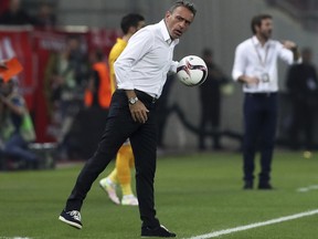 FILE - In this Sept. 29, 2016 file photo, then Olympiakos' coach Paulo Bento holds the ball during the Europa League Group B soccer match between Olympiakos and APOEL at Georgios Karaiskakis stadium in Piraeus port, near Athens.  South Korea has appointed ex-Portugal manager Paulo Bento as head coach of the national team. The 49 year-old Bento is charged with leading the team to the 2022 World Cup in Qatar and replaces Shin Tae-yong, who was not offered a new contract in July after South Korea's group-stage exit at the World Cup in Russia.