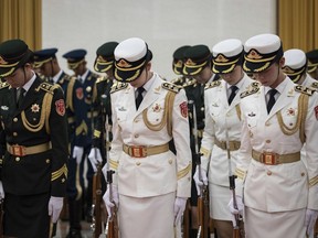 Female members of Chinese People's Liberation Army honor guard prepare for the welcome ceremony for President of Botswana Mokgweetsi Masisi at the Great Hall of the People in Beijing, China, Friday, Aug. 31, 2018.
