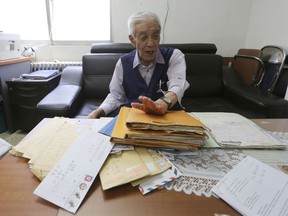 In this Aug. 22, 2018, photo, Kim Kyung-jae, 86, speaks in front of letters sent from his North Korean sister during an interview at his office in Seoul, South Korea. Kim is one of a dwindling number of elderly South Koreans who, frustrated with North Korea's reluctance to allow more frequent reunions and by the small chance that they'll be selected before they die, found unofficial networks to communicate with their North Korean relatives.