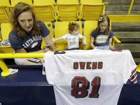 Molly Cooper, left, sits with her children Sidney, 2, center, and Clarke, 8, as they wait for former wide receiver Terrell Owens to deliver his NFL Pro Football Hall of Fame speech on Saturday, Aug. 4, 2018, in Chattanooga, Tenn. Instead of speaking at the Hall of Fame festivities in Canton, Ohio, Owens is celebrating his induction at the University of Tennessee at Chattanooga, where he played football and basketball and ran track.