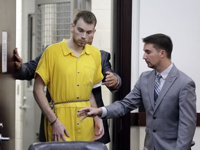 Travis Reinking, left, enters a courtroom for a hearing Wednesday, Aug. 22, 2018, in Nashville, Tenn. Reinking is charged with killing four people during a shooting at a Waffle House restaurant in Nashville in April.