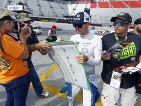 Kyle Larson signs autographs before practice for a NASCAR Cup Series auto race, Friday, Aug. 17, 2018, in Bristol, Tenn.