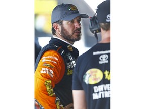 Martin Truex talks with a crew member during practice for a NASCAR Cup Series auto race, Friday, Aug. 17, 2018, in Bristol, Tenn.