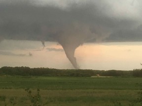 Pictures taken by Bryan Mozdzen of a tornado that touched down near Alonsa, Manitoba, on Friday, Aug. 3, 2018.