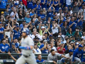 Toronto Blue Jays fans cheer and Seattle Mariners fans sit in their seats as Randal Grichuk scores in the third inning at Safeco Field on Aug. 4.
