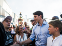 Prime Minister Justin Trudeau greets people on Toronto's Danforth Avenue in Toronto, Aug. 10, 2018.